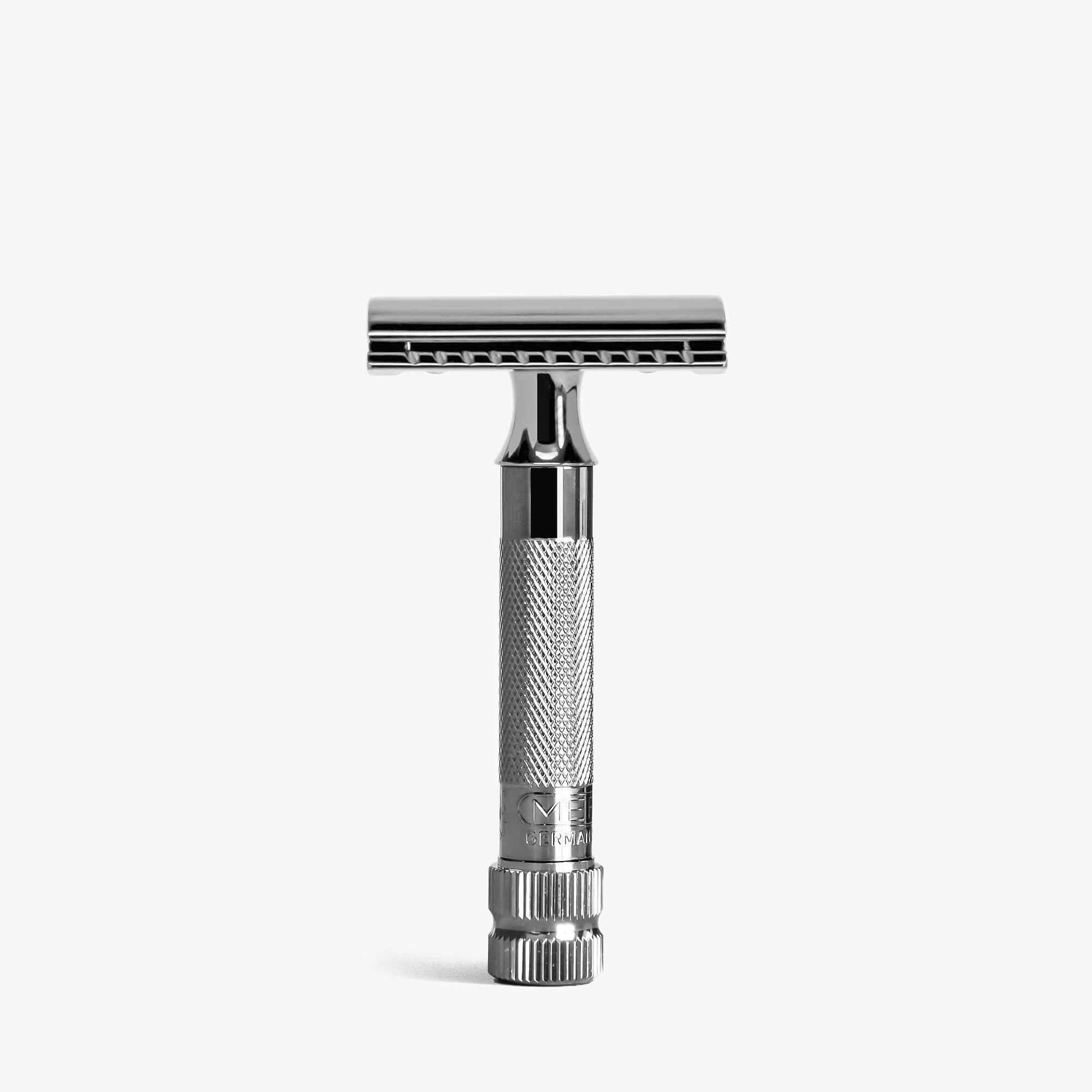 A Merkur 34c double-edge safety razor with a metallic grey finish, standing upright on a light grey background.