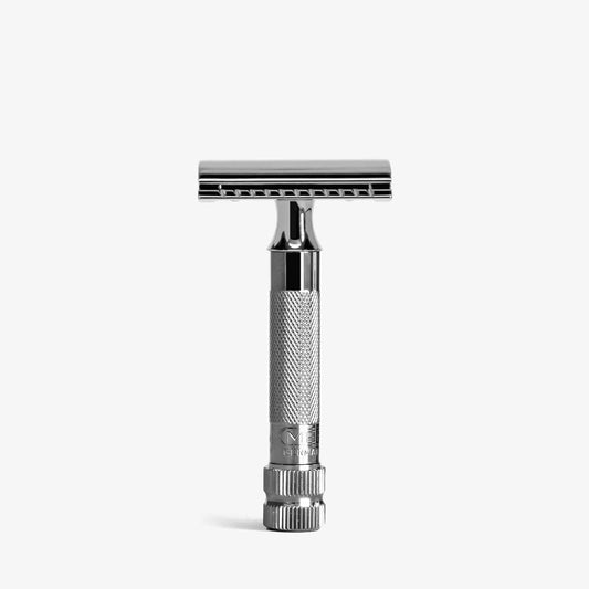 A Merkur 34c double-edge safety razor with a metallic grey finish, standing upright on a light grey background.