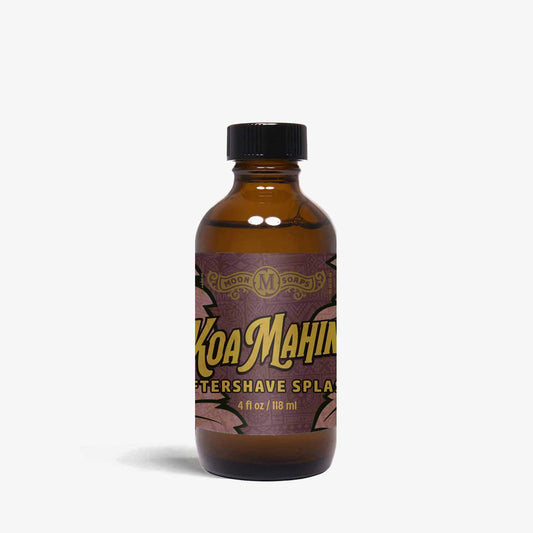 A bottle of Koa Mahin aftershave splash with a black cap on a white background